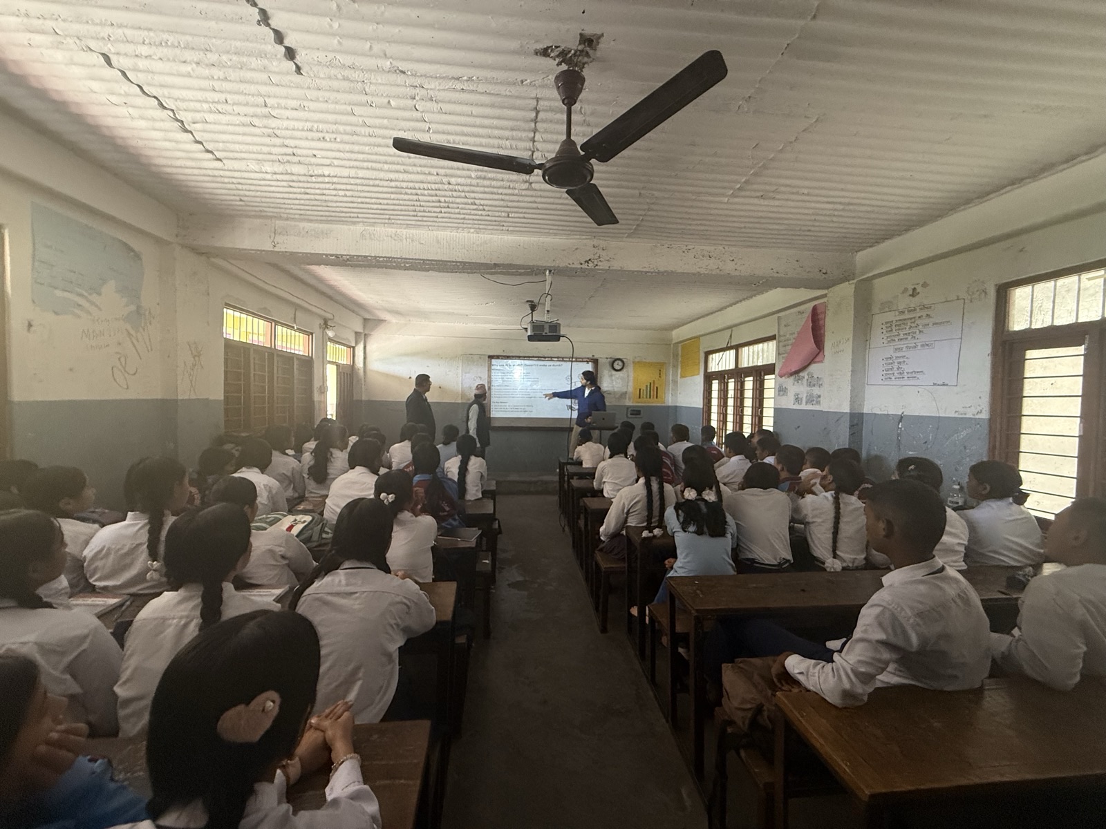 Wide view of the classroom at Shree Pardi Secondary School during the AI session, students at desks facing a projected slide